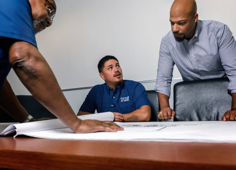 Tecton team working in office looking at engineering plans